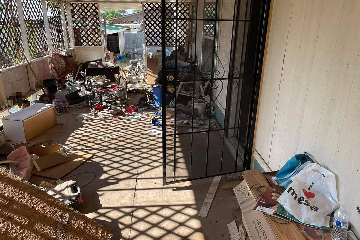 Cluttered porch before cleanup