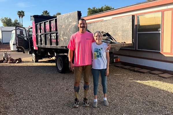 Pinks crew with happy customer after junk removal