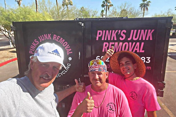 Pinks crew with happy customer after junk removal