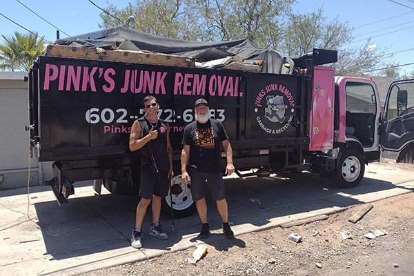 Pinks crew with happy customer after junk removal