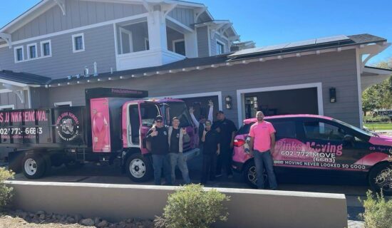 A group of people standing around a barbecue trailer outside a house. A group of people standing around a barbecue trailer outside a house.