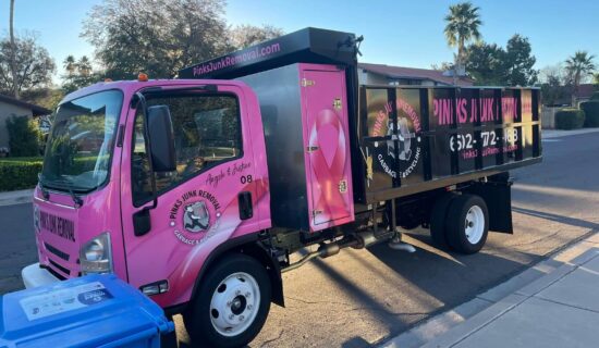 A pink and black truck with floral designs parked on a street. A pink and black truck with floral designs parked on a street.